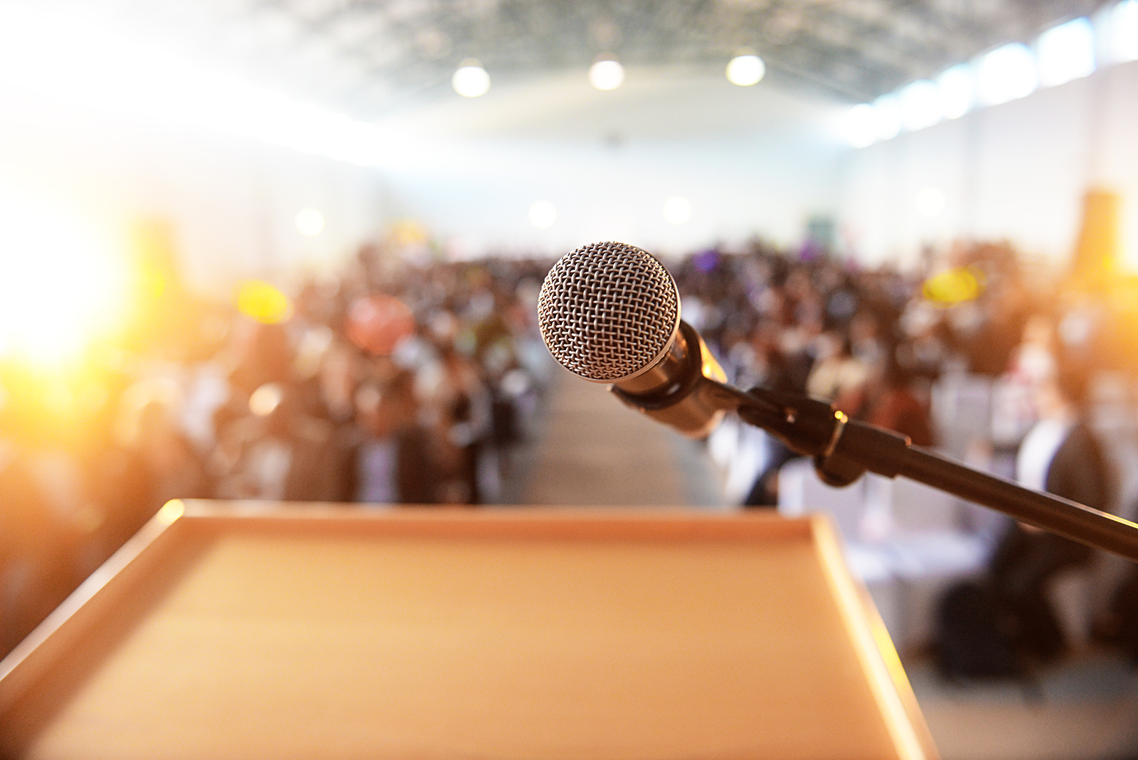 podium and microphone in front of a conference audience